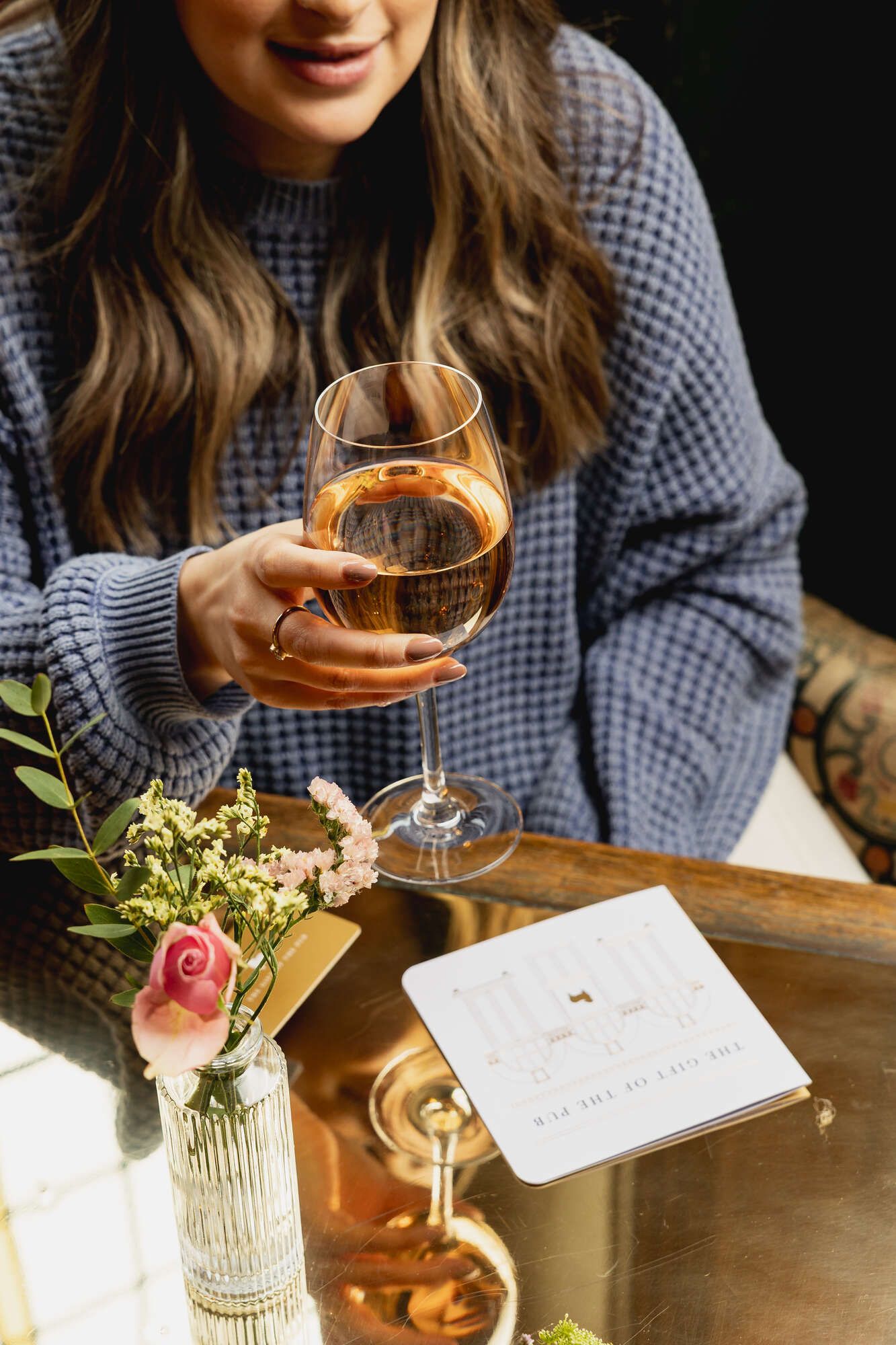 Mother’s Day celebration at a riverside pub with a vase of fresh spring flowers, a glass of Rose wine, and a cosy table setting by the River Avon.