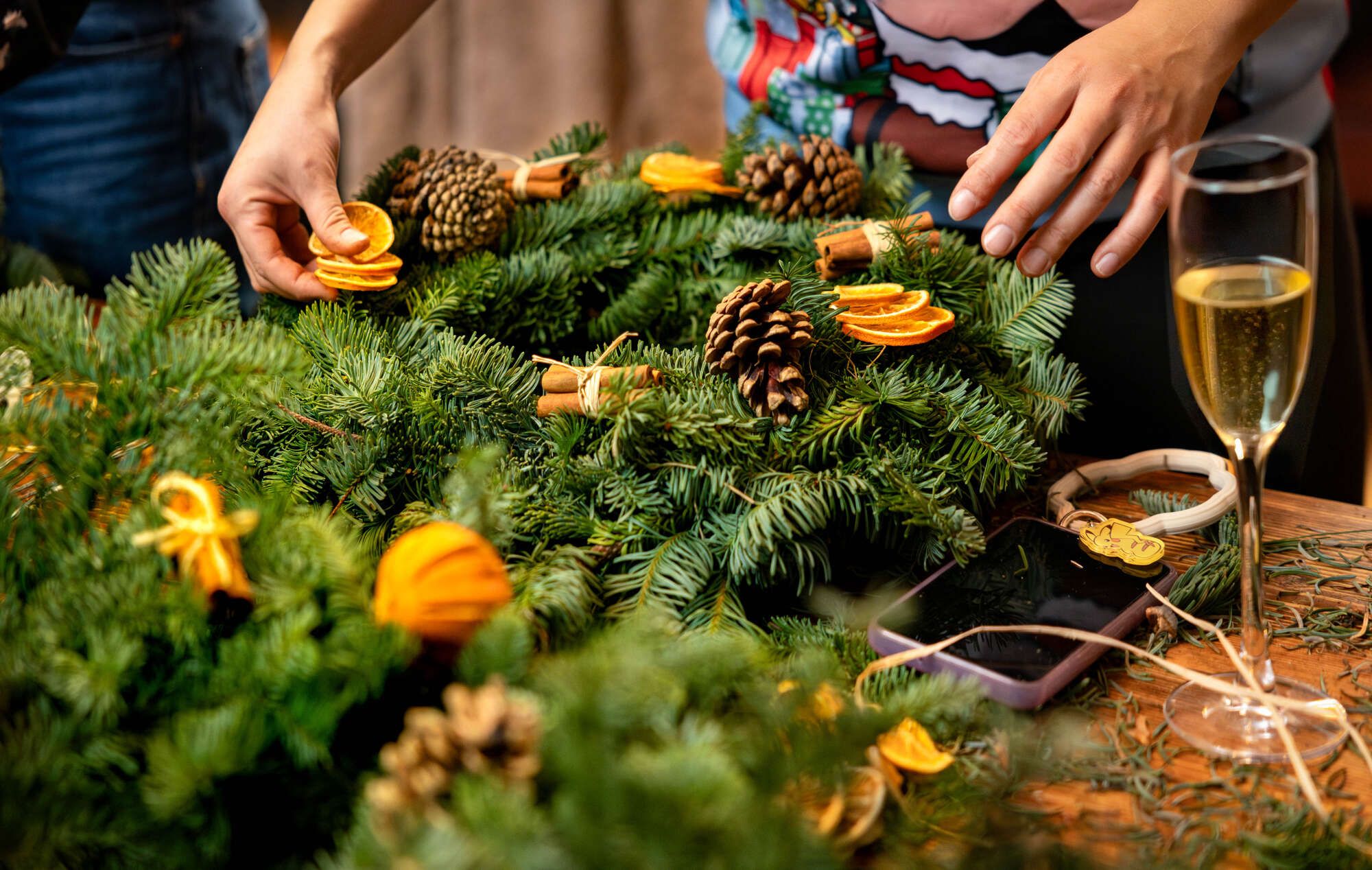 Christmas Wreath making with a glass of bubbles on hand