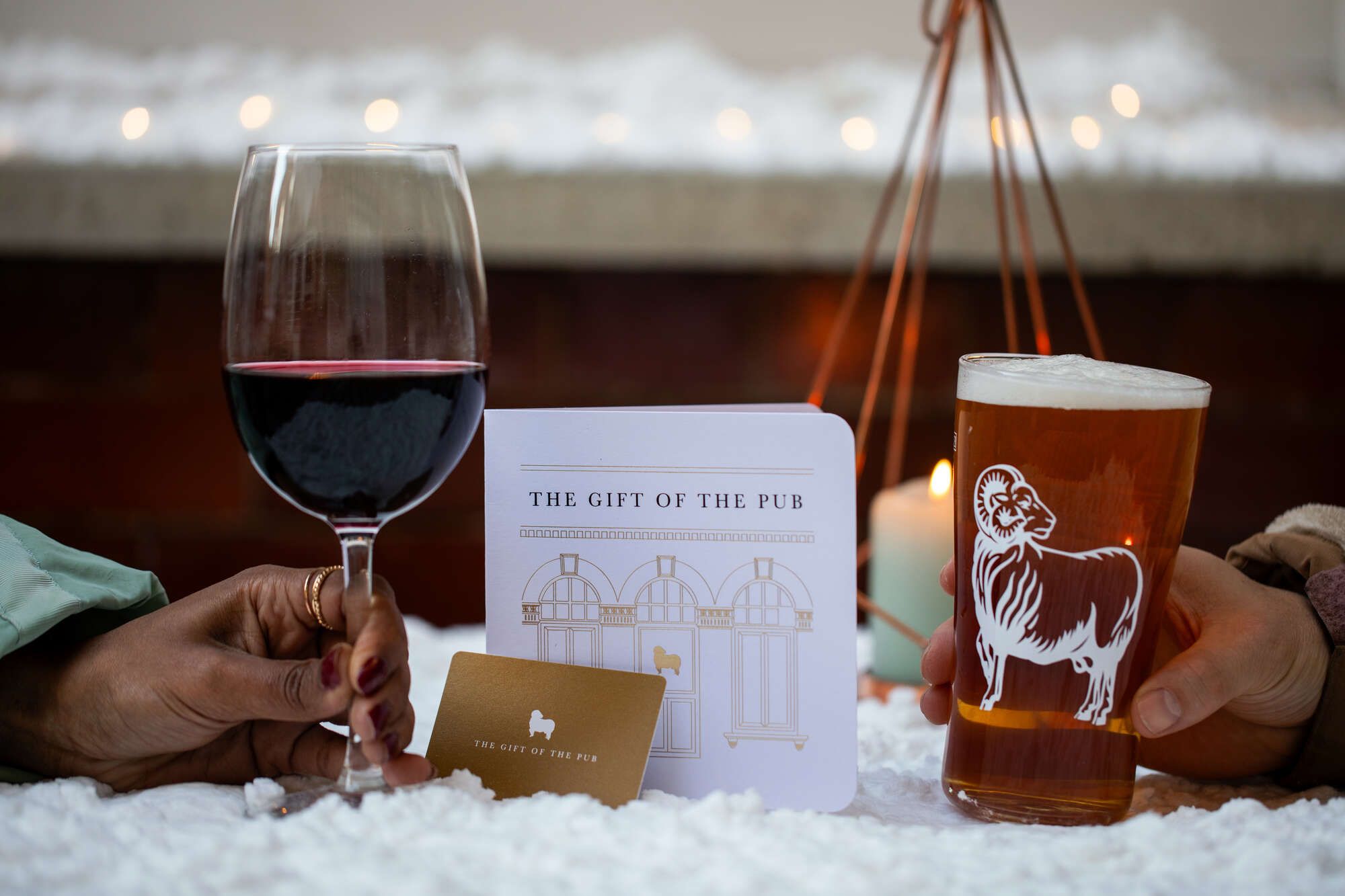 Gift Voucher in the smow with a pint of Youngs Original & glass of red wine
